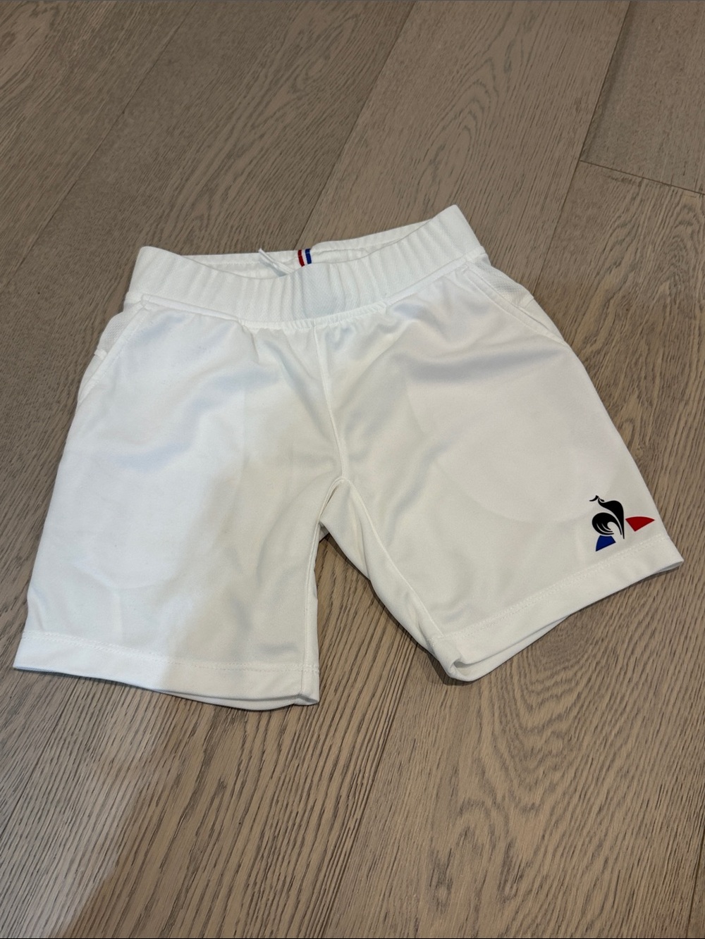 Le Coq Sportif White Shorts with Blue and Red Logo